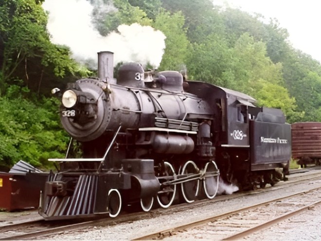 328 upscaled a steam engine train traveling down train tracks near a forest